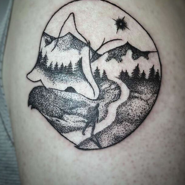 black and white tattoo of a fox curled up and a mountain scene in the body