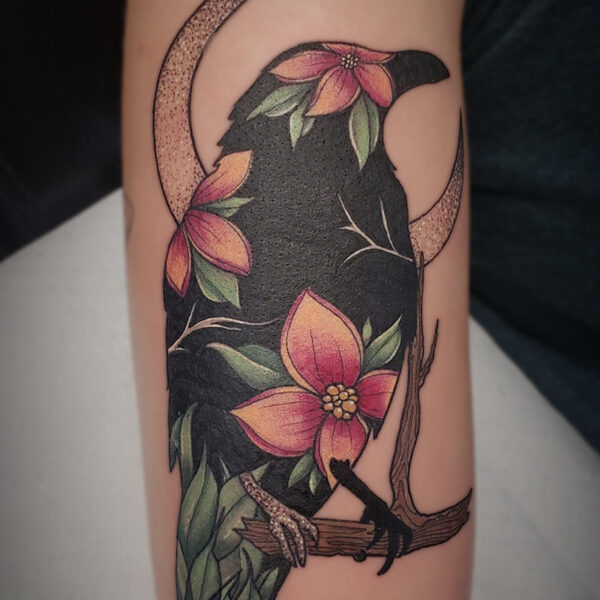 atticus tattoo, coloured tattoo of a raven with flowers in the body and a crescent moon in the background