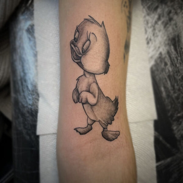 atticus tattoo, black and white tattoo of a cartoon duck