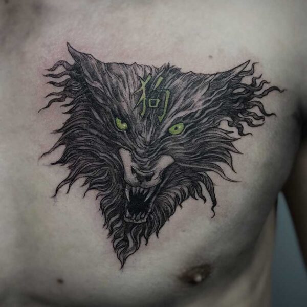 atticus tattoo, black and white tattoo of a werewolf's face with green eyes
