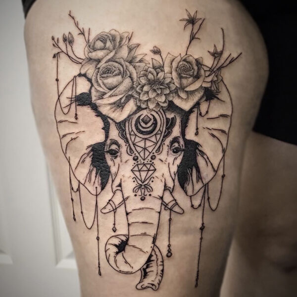atticus tattoo, black and grey tattoo of an elephant with flowers and jewels