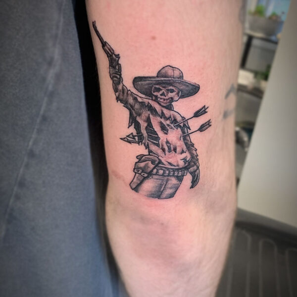 atticus tattoo, black and grey tattoo of a zombie cowboy shooting a gun