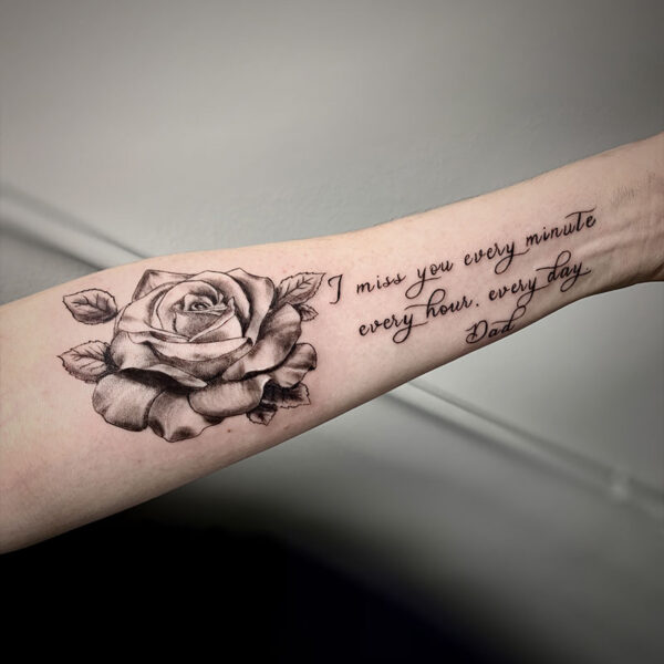 atticus tattoo, black and grey realism tattoo of a rose and a quote