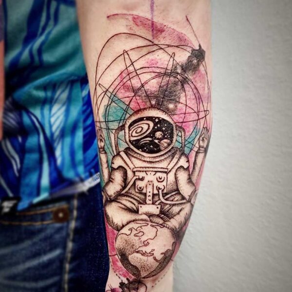 atticus tattoo, coloured tattoo of an four armed astronaut meditating over earth and a galaxy behind them