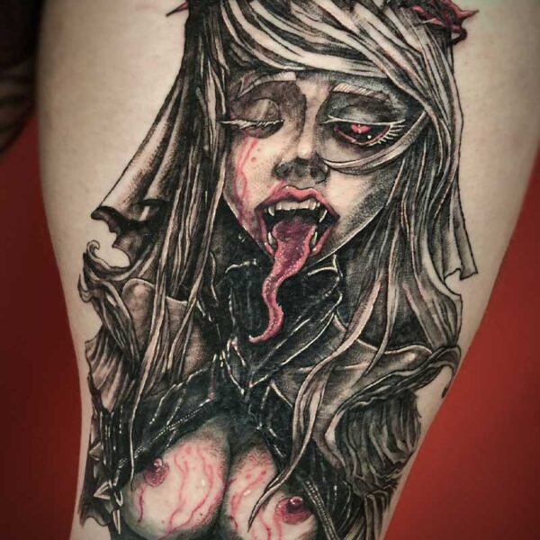 atticus tattoo, black and red tattoo of a half naked woman with a crown of thorns, serpent tongue and blood dripping down her chest