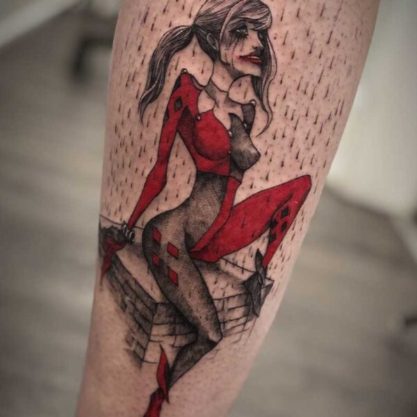 atticus tattoo, coloured tattoo of a stylized Harley Quinn that is looking up in the rain and crying