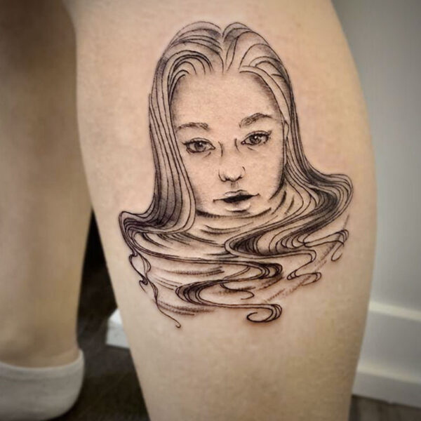 atticus tattoo, black and grey tattoo of a woman's face and looks like she's floating in water