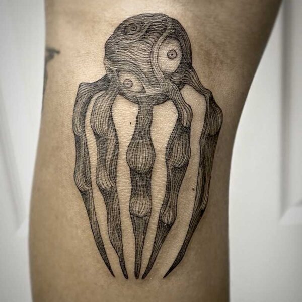 atticus tattoo, black and grey tattoo of a monster with a round body and five legs