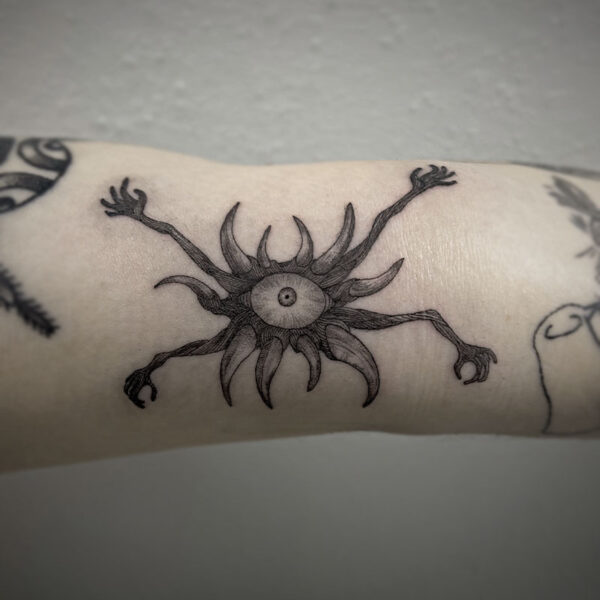 atticus tattoo, black and grey tattoo of a monster with four arms, tentacles and an eyeball