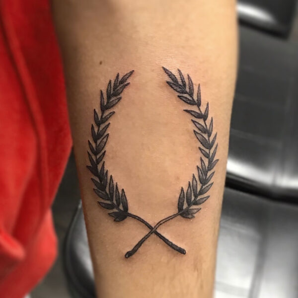 atticus tattoo, black and grey tattoo of two stems of leaves