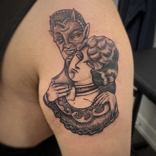 atticus tattoo, black and grey vintage style tattoo of a devil grasping a woman who has bite marks on her neck