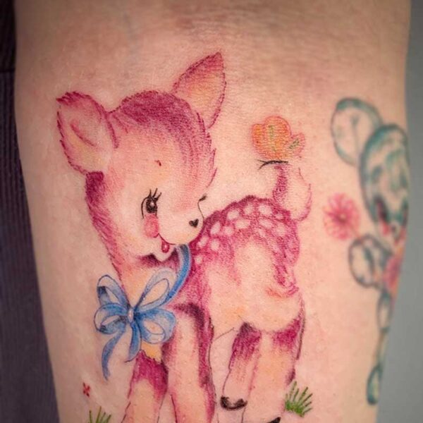 atticus tattoo, coloured tattoo of a cartoon deer standing in a field of flowers