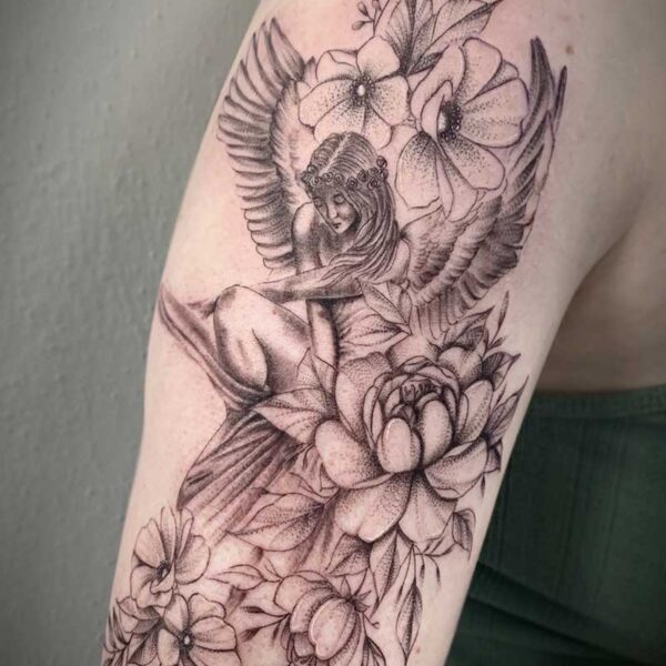 atticus tattoo, fine line tattoo of an angle looking down with flowers surrounding her