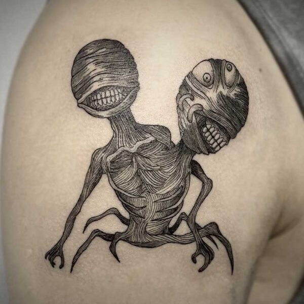 atticus tattoo, black and grey tattoo of a monster with two heads
