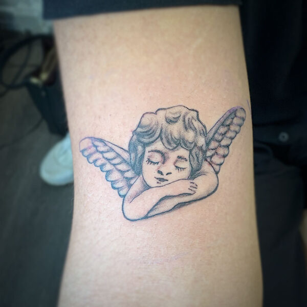 atticus tattoo, black and grey tattoo of a cherub
