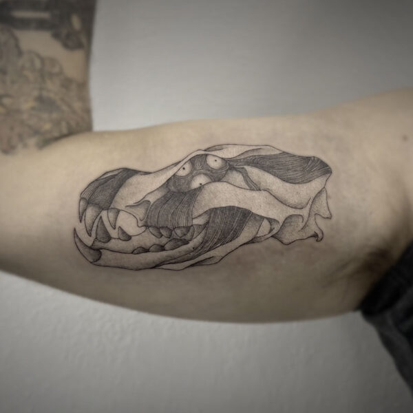 atticus tattoo, black and grey tattoo of a bear skull with exposed muscle
