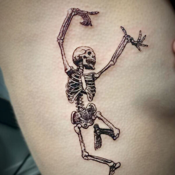 atticus tattoo, black and grey tattoo of a skeleton dancing