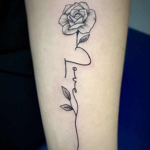 atticus tattoo, rose tattoo with the word "love" as the stem