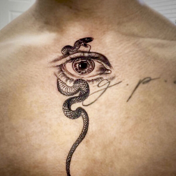 atticus tattoo, black and grey tattoo of a human eye with a snake wrapping around it