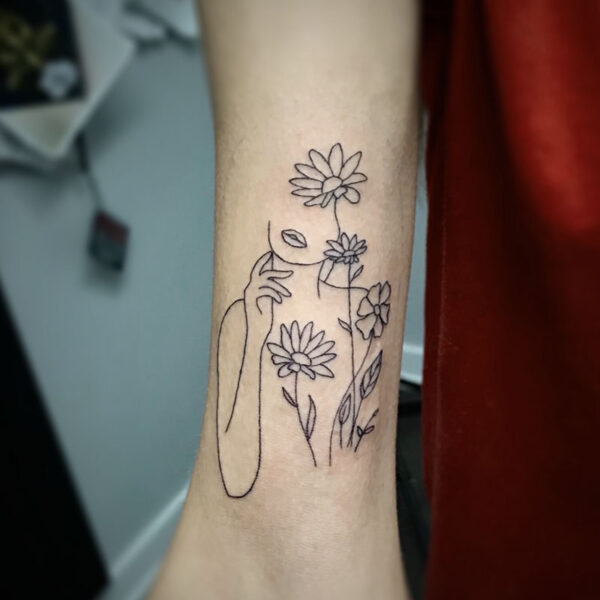 atticus tattoo, line tattoo of a woman and daisies