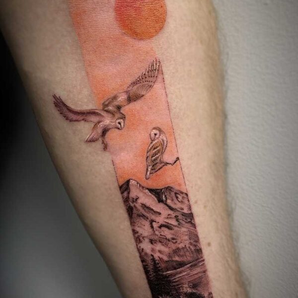 atticus tattoo, coloured tattoo of a rectangle with a sunset mountain scene and snowy owls