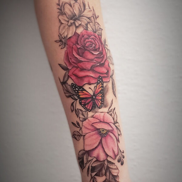 atticus tattoo, coloured tattoo of a rose, butterfly and poppy with black and grey foliage behind them
