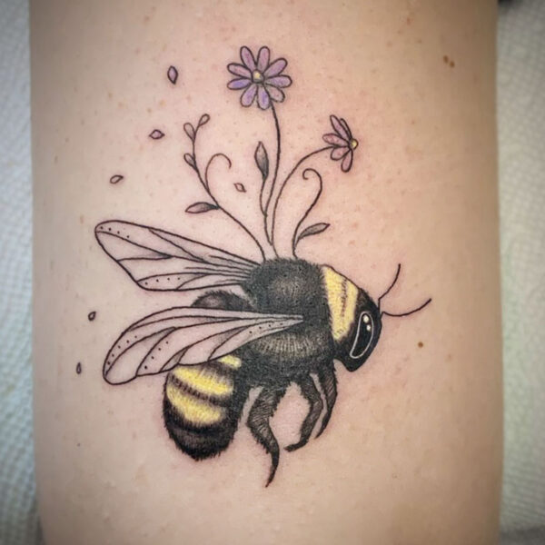 atticus tattoo, coloured tattoo of a bumble bee with small purple flowers growing out of it