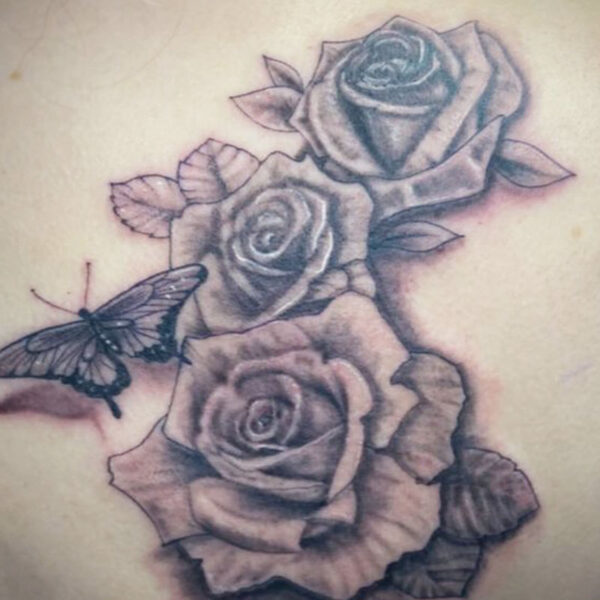 atticus tattoo, black and grey realism tattoo of roses and a butterfly
