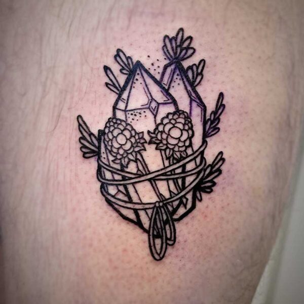atticus tattoo, black line tattoo of crystals with berries and leaves tied around them