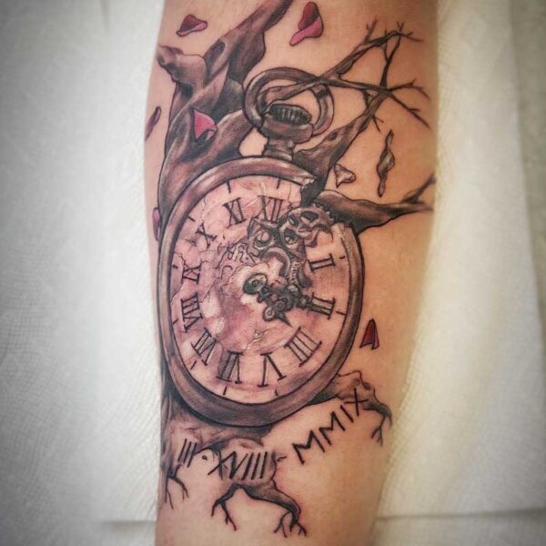 atticus tattoo, black and grey tattoo of an antique stop watch with a tree and blossoms in the background