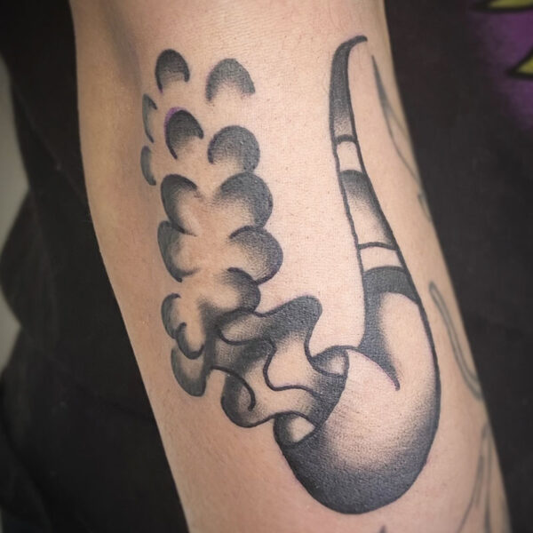atticus tattoo, black and grey american traditional style tattoo of a tobacco pipe that is smoking