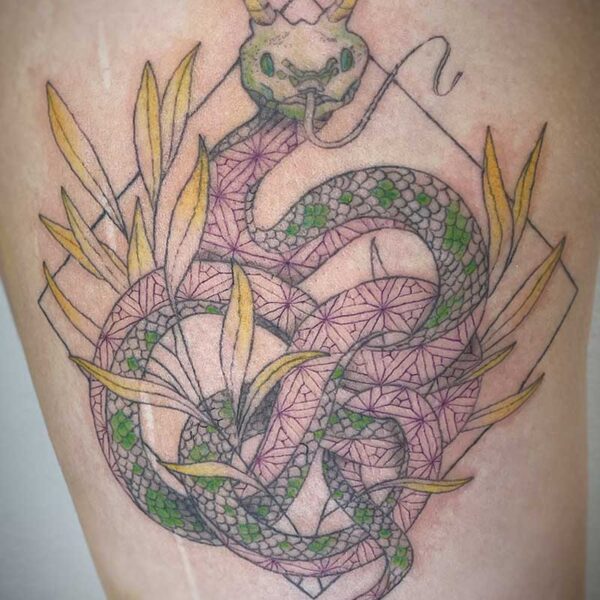 atticus tattoo, fine line, coloured tattoo of a snake with horns and a pattern on its underside, surrounded by golden leaves