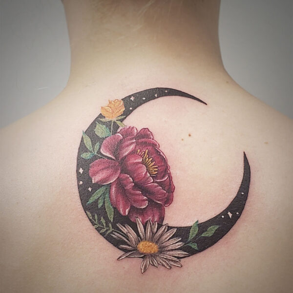 atticus tattoo, coloured tattoo of a black, crescent moon with flowers on it