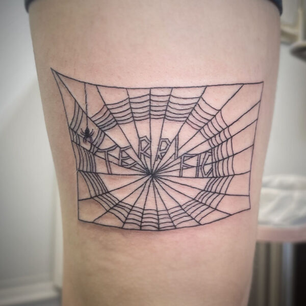 atticus tattoo, fine line tattoo of Charolette's web with the word terrific