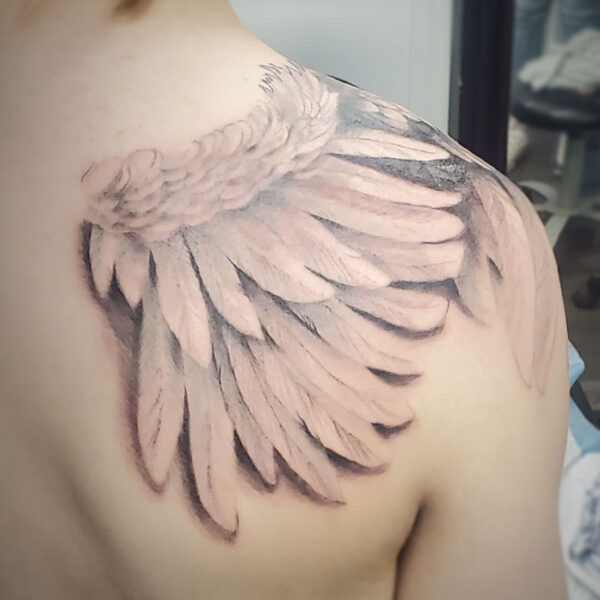 atticus tattoo, black and grey tattoo of a wing