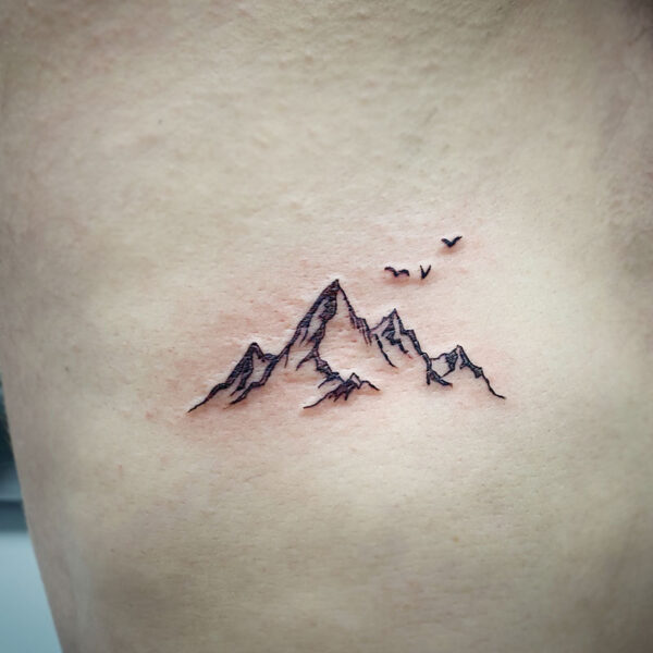atticus tattoo, fine line tattoo of a mountain range