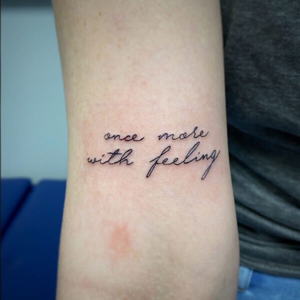 atticus tattoo, fine line tattoo of the words "one more time with feeling"