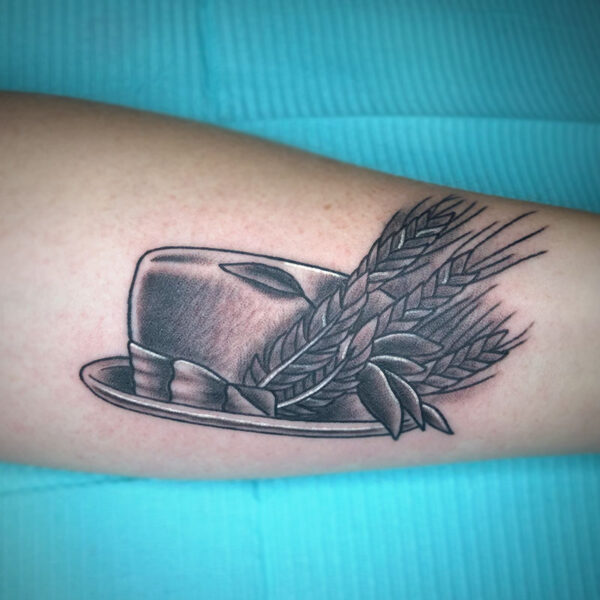 atticus tattoo, black and grey tattoo of a fedora with stalks of wheat in the brim
