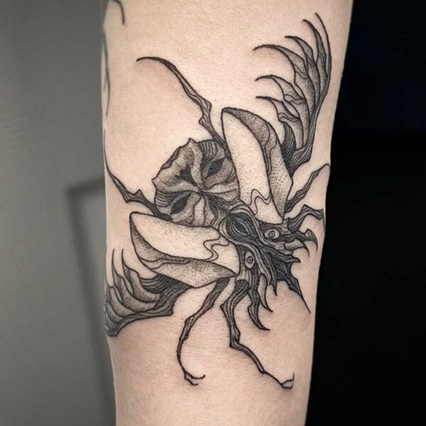 atticus tattoo, black and grey tattoo of a beetle monster