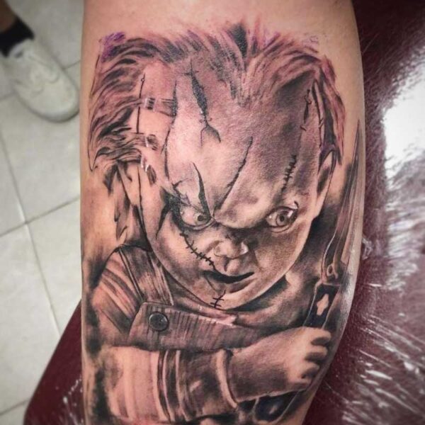 atticus tattoo, black and grey realism tattoo of Chucky