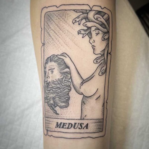 atticus tattoo, black and grey tattoo of a card with Medua holding a man's head