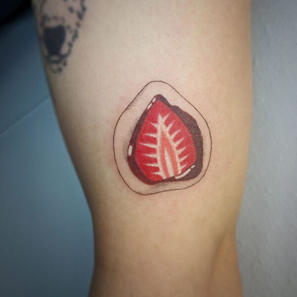 atticus tattoo, coloured tattoo of a strawberry slice