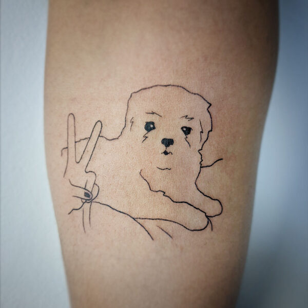 atticus tattoo, fine line tattoo of a small dog and someone giving a peace sign