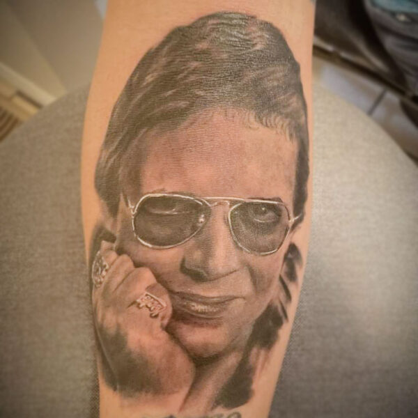 atticus tattoo, black and grey realism tattoo of a portrait of a man with sunglasses
