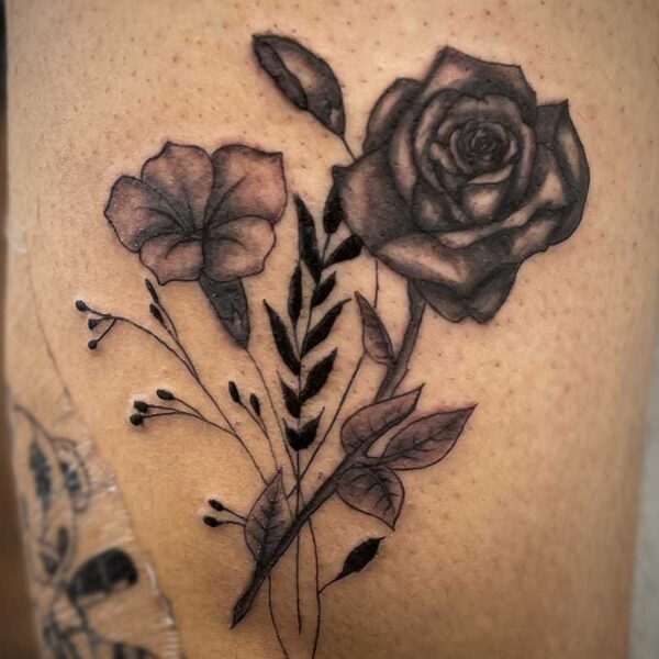 atticus tattoo, a mix of fine line and realism tattoo of a rose and other flowers