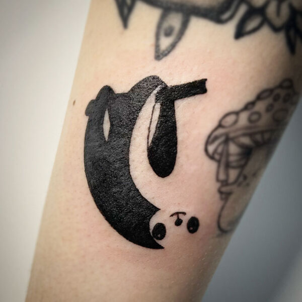 atticus tattoo, black tattoo of a sloth hanging from a branch