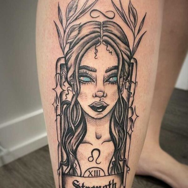 atticus tattoo, black and grey tattoo of a strength tarot card with a woman on the card