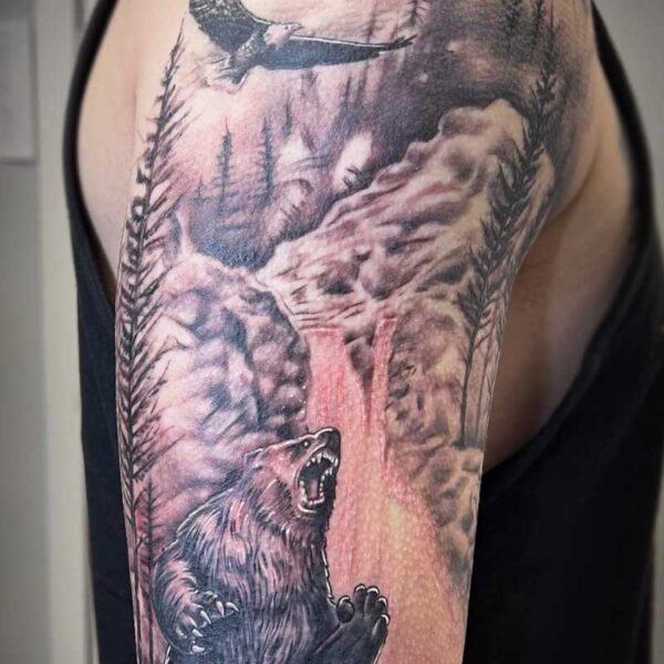 atticus tattoo, black and white realism tattoo of a grizzly bear with a waterfall and eagle in the background