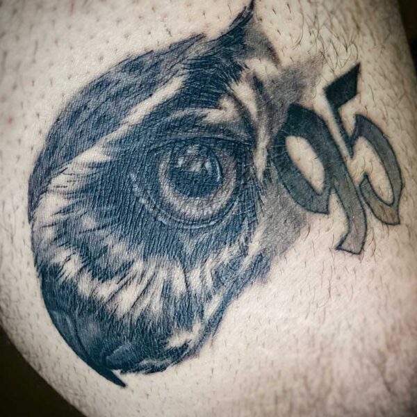 atticus tattoo, black and grey realism tattoo of an owls face