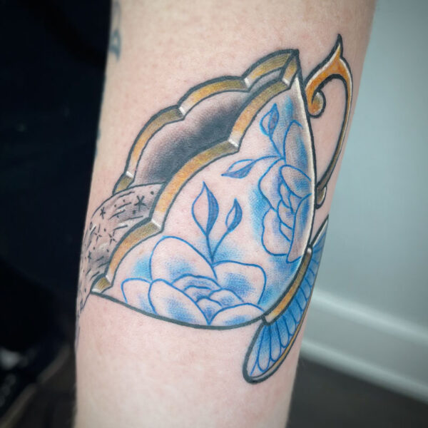 atticus tattoo, coloured tattoo of a teacup with blue roses
